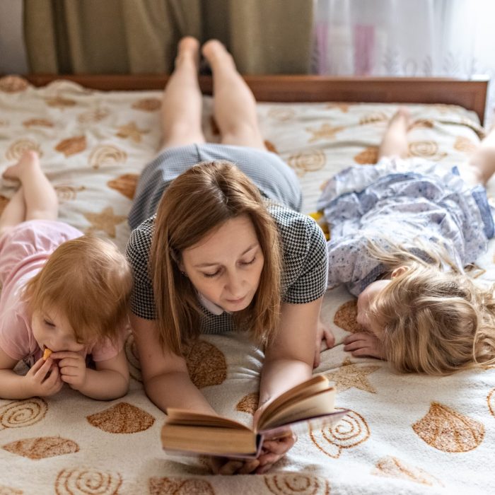 mom-and-daughters-are-reading-a-book-2022-11-12-07-53-07-utc